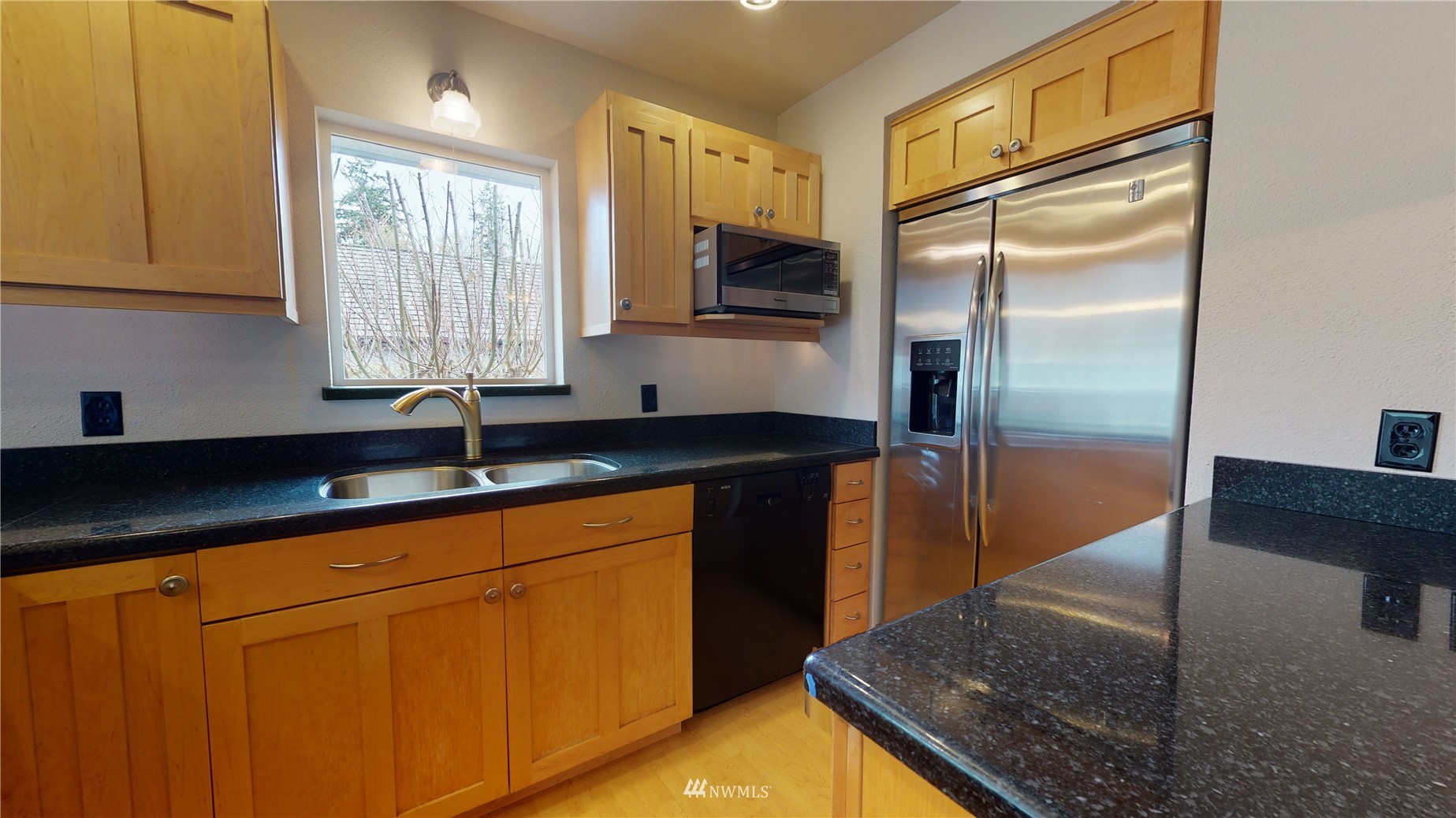 2530 Mountain View Road East Port Orchard, WA 98366 - Photo 19 of 34 a kitchen with granite countertop a refrigerator a sink and dishwasher