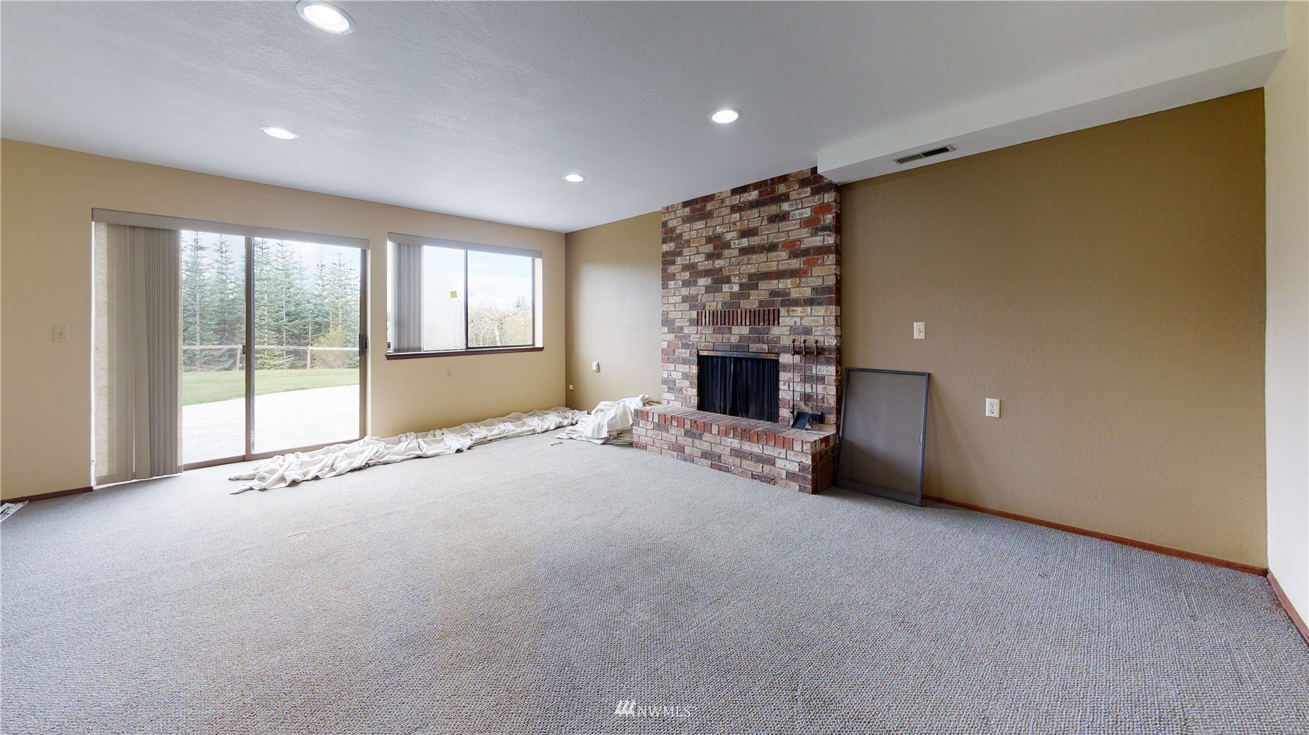 2530 Mountain View Road East Port Orchard, WA 98366 - Photo 26 of 34 a view of an empty room with a fireplace and a window