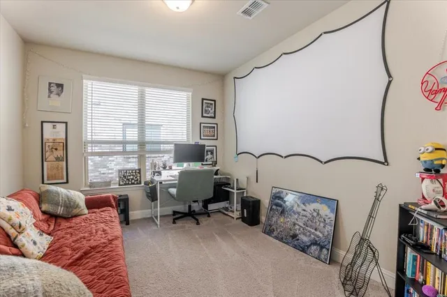 a living room with furniture and a floor to ceiling window