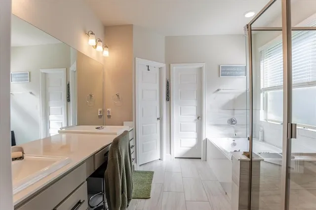 a bathroom with a double vanity sink mirror and double
