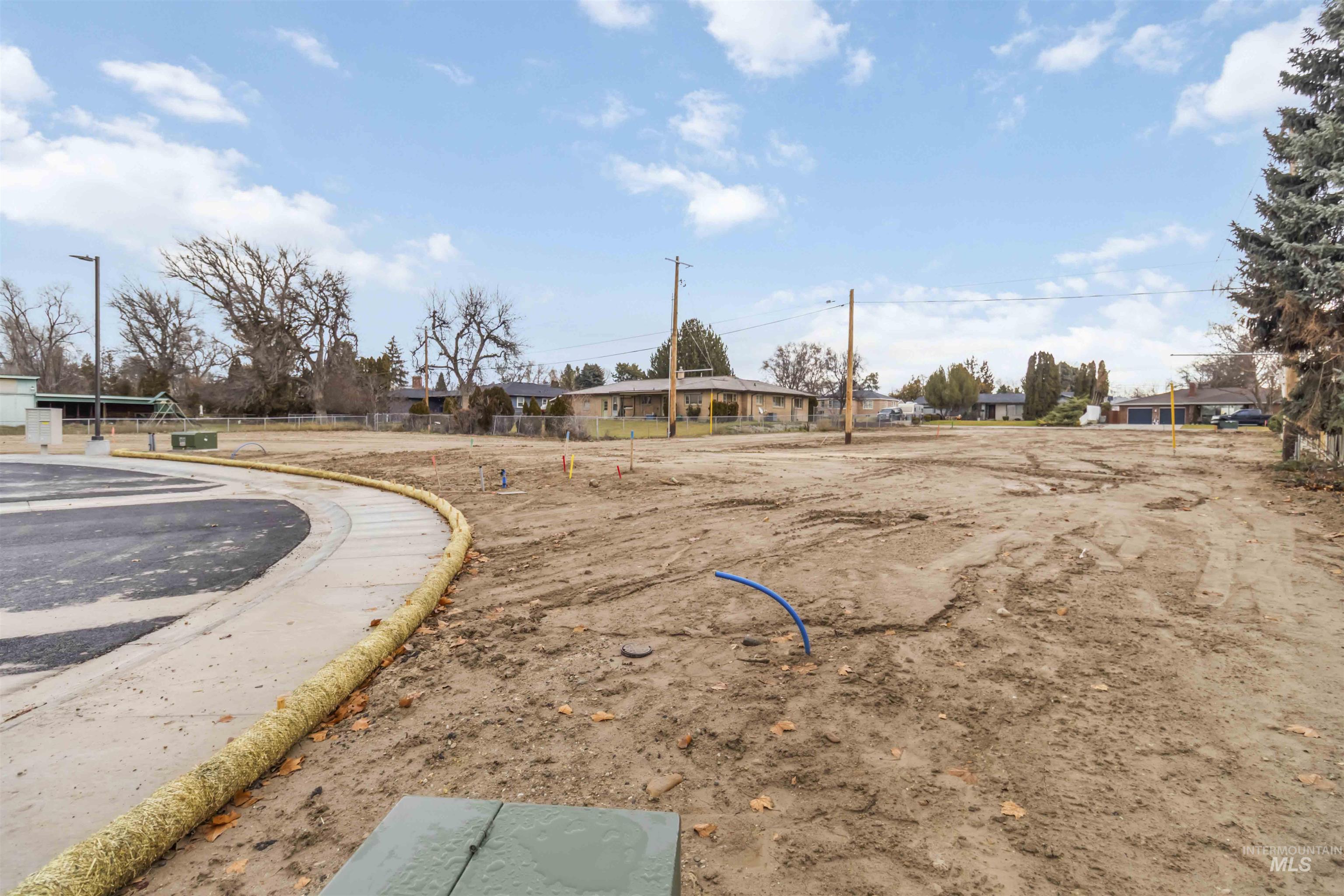 Oregon Avenue Caldwell, ID 83605 - Photo 34 of 42 View of asphalt road featuring street lighting and curbs