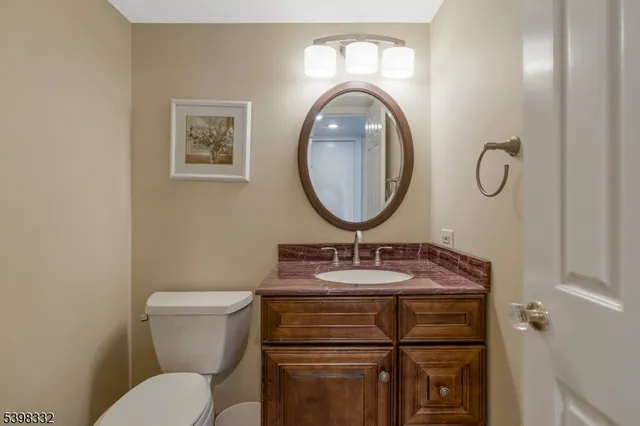 a bathroom with a toilet a sink and a mirror