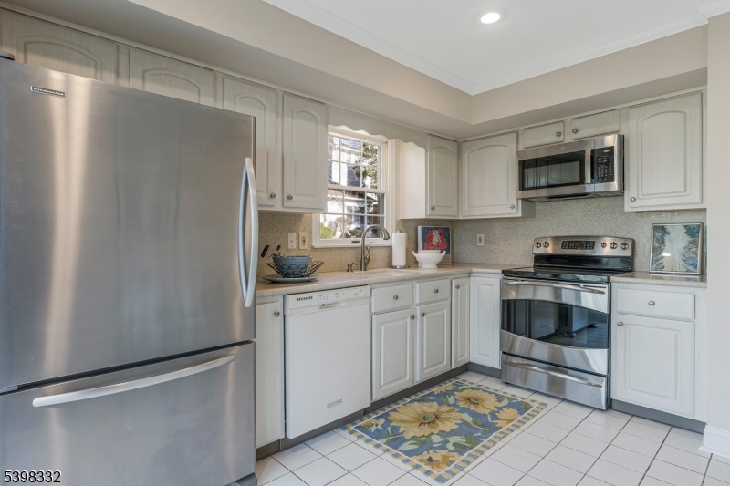 46 Eton Court Bedminster, NJ 07921 - Photo 12 of 30 a kitchen with stainless steel appliances granite countertop a refrigerator sink and cabinets