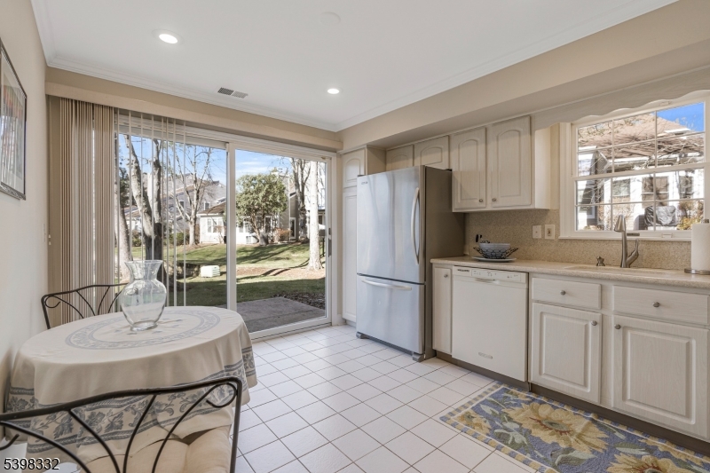 46 Eton Court Bedminster, NJ 07921 - Photo 13 of 30 a kitchen with a table chairs and refrigerator