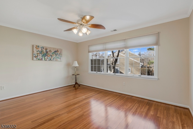 46 Eton Court Bedminster, NJ 07921 - Photo 15 of 30 a view of an empty room with a window and wooden floor