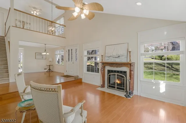 a living room with furniture a fireplace and a floor to ceiling window