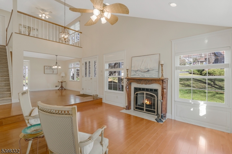 46 Eton Court Bedminster, NJ 07921 - Photo 2 of 30 a living room with furniture a fireplace and a floor to ceiling window