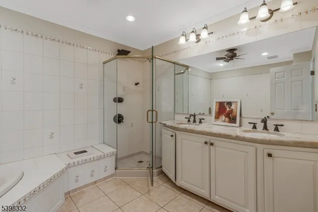 a bathroom with a double vanity sink mirror bathtub and shower