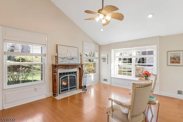 a living room with furniture fireplace and window