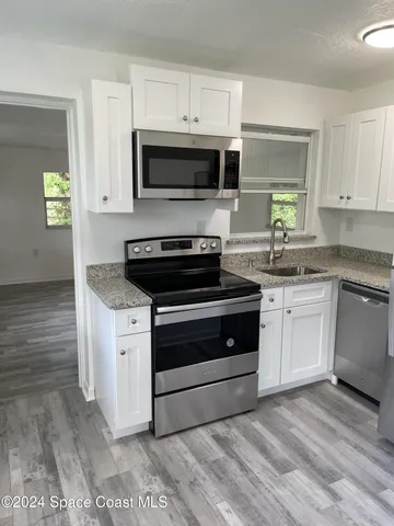 a kitchen with a stove and a microwave