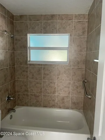 a bathroom with a shower and a bathtub