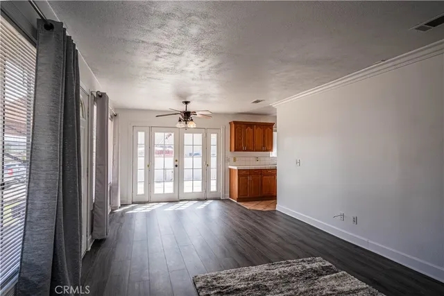 a view of a room with wooden floor and windows