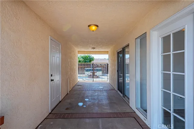 a view of a hallway with wooden shelves