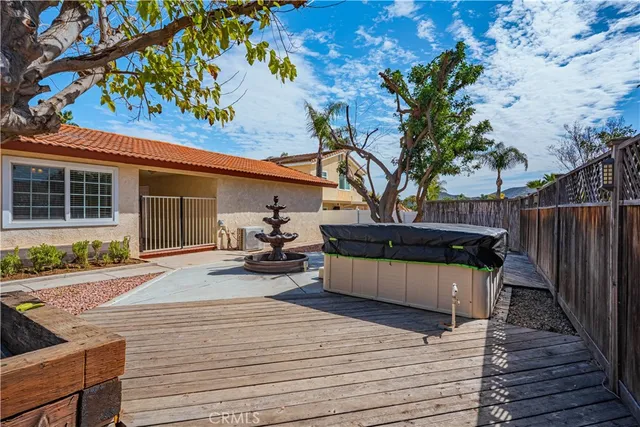 a view of a deck with chairs and wooden fence