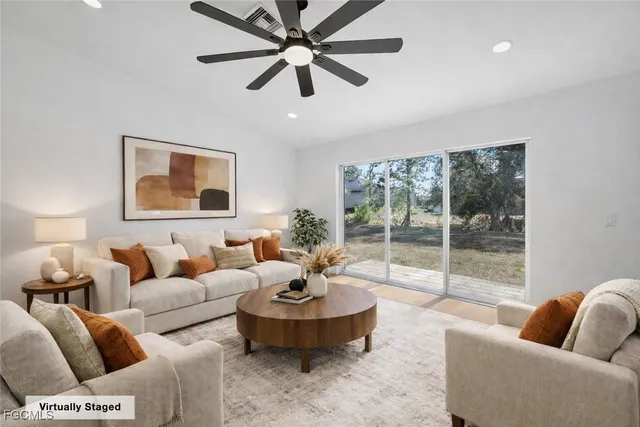 a living room with furniture and a large window
