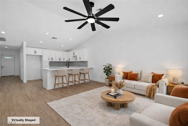 a living room with furniture and a dining table