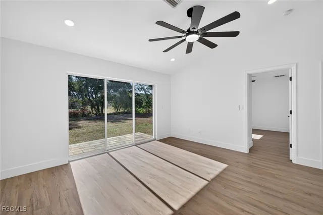 a view of room with wooden floor and fan