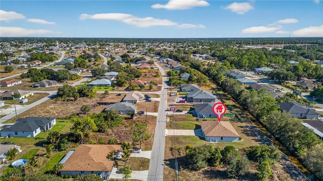 an aerial view of residential houses with outdoor space and street view
