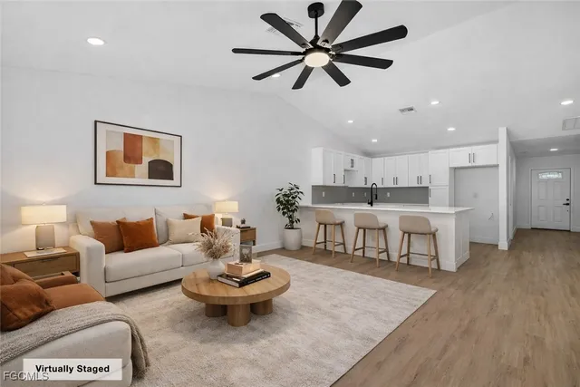 a living room with furniture and kitchen view