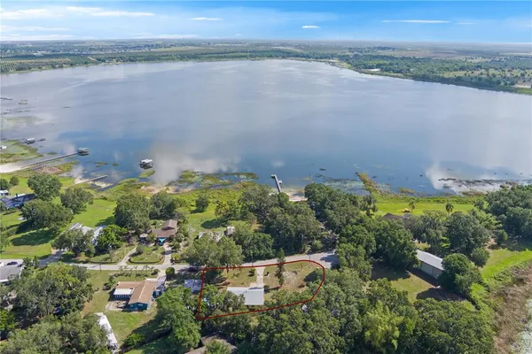 an aerial view of a houses with a lake view