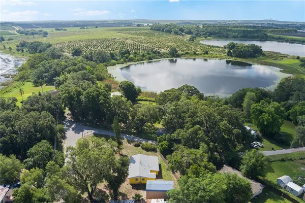 an aerial view of a houses with outdoor space and lake view