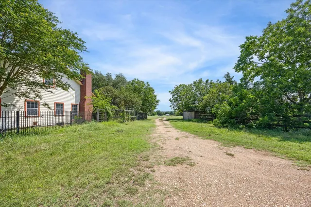 a view of an empty room with a fireplace and a window
