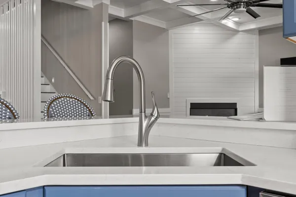 a kitchen with a refrigerator and white cabinets