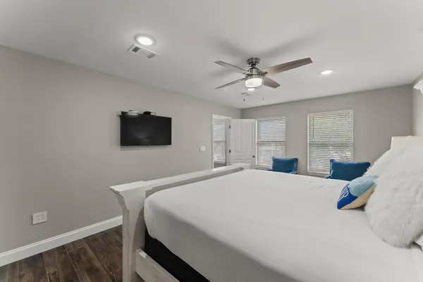 a bedroom with furniture and a window