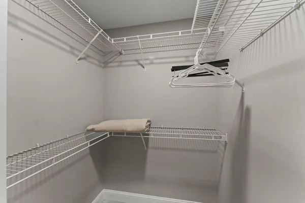 a bedroom with a bed and a mirror