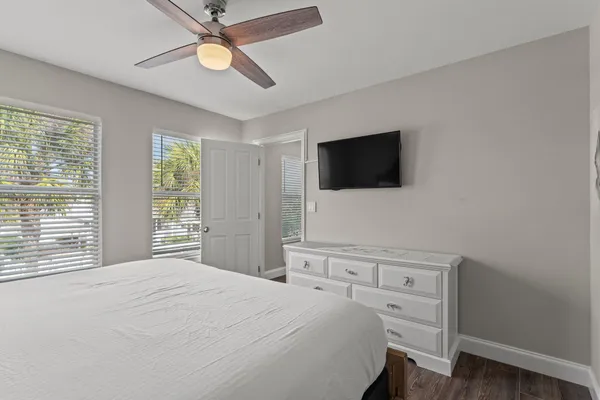 a bedroom with a bed and a painting on the wall