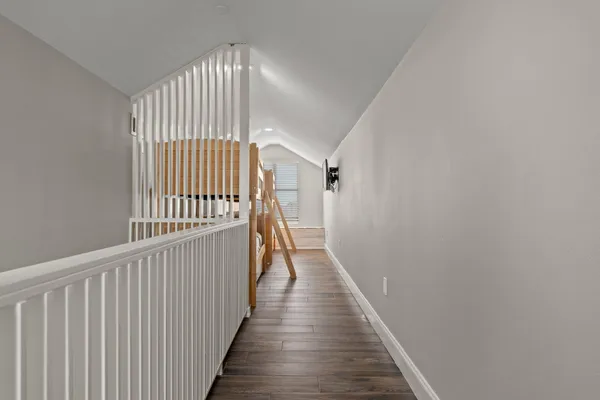 a balcony with couch and wooden floor
