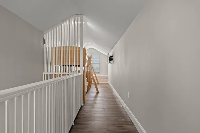 a balcony with couch and wooden floor
