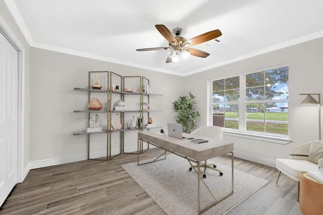 a view of a livingroom with furniture window and wooden floor