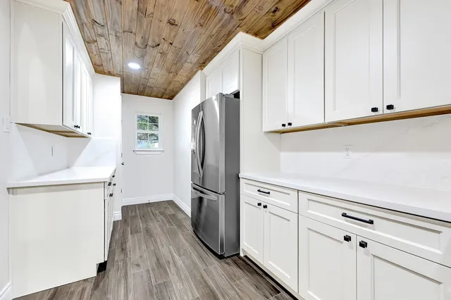 a kitchen with stainless steel appliances a refrigerator and cabinets