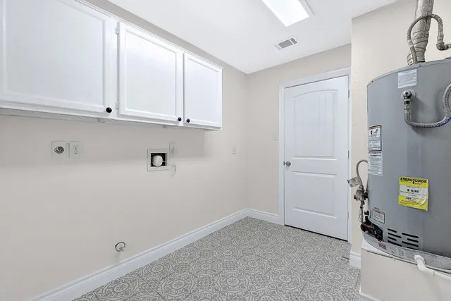 a view of storage and utility room with closet