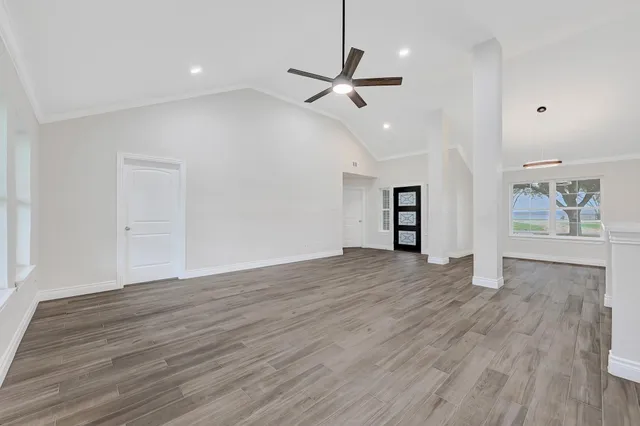 a view of empty room with wooden floor