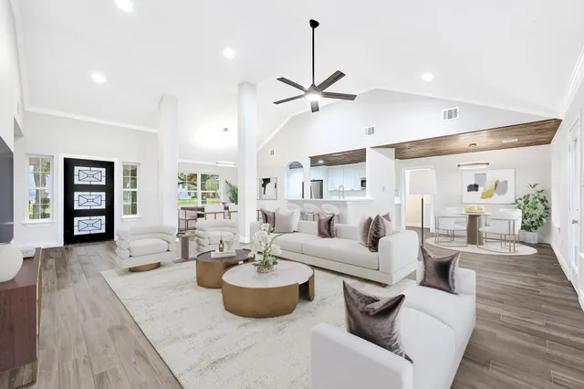 a living room with furniture a rug and white walls