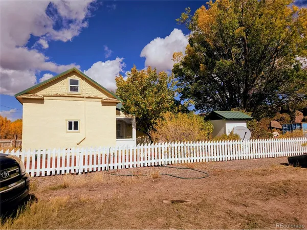 a view of a house with a fence