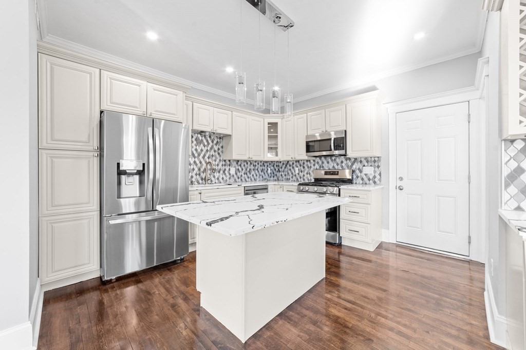 44 Bowdoin Street, Unit 2 Boston, MA 02124 - Photo 13 of 33 a kitchen with stainless steel appliances a refrigerator sink and microwave