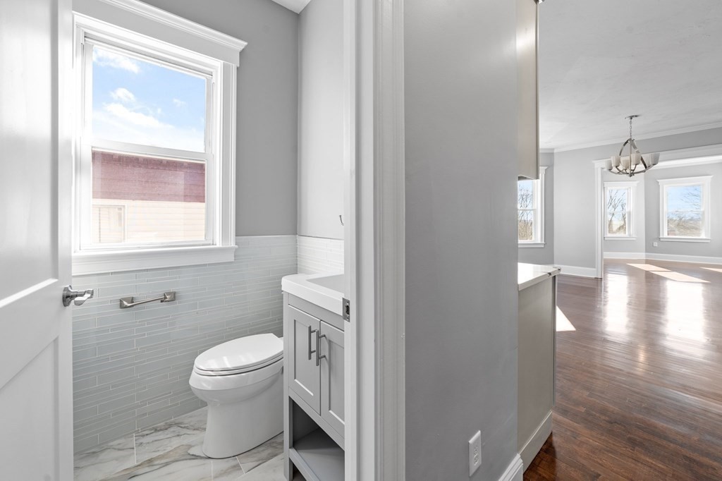 44 Bowdoin Street, Unit 2 Boston, MA 02124 - Photo 16 of 33 a white toilet sitting next to a bathroom sink