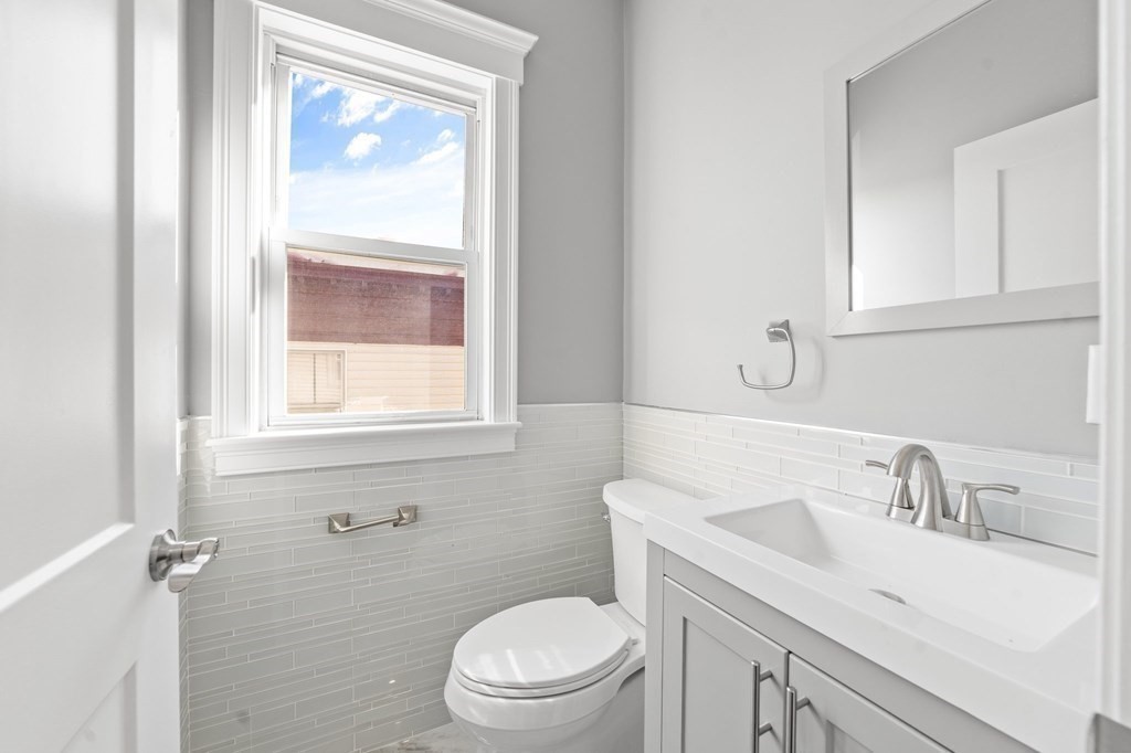 44 Bowdoin Street, Unit 2 Boston, MA 02124 - Photo 17 of 33 a bathroom with a sink a toilet and a window