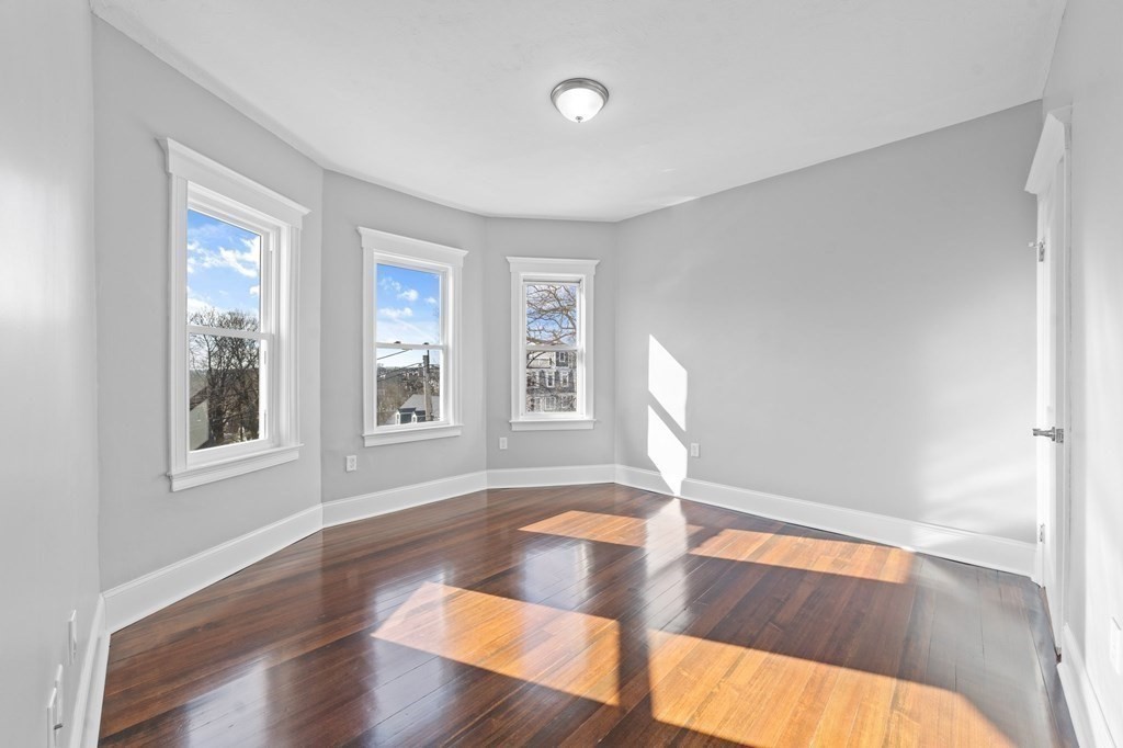 44 Bowdoin Street, Unit 2 Boston, MA 02124 - Photo 20 of 33 a view of empty room with wooden floor and fan