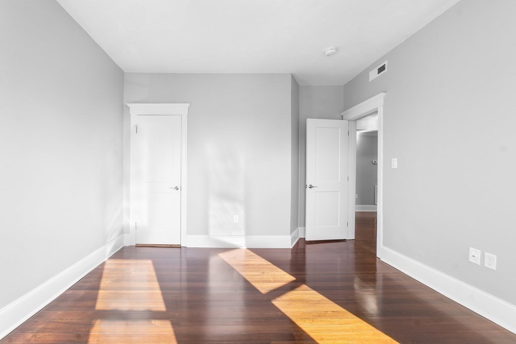44 Bowdoin Street, Unit 2 Boston, MA 02124 - Photo 24 of 33 a view of room with window and wooden floor