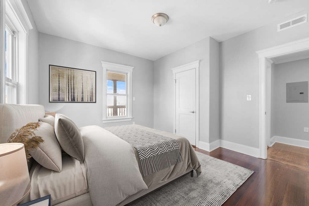44 Bowdoin Street, Unit 2 Boston, MA 02124 - Photo 26 of 33 a bedroom with a bed and wooden floor