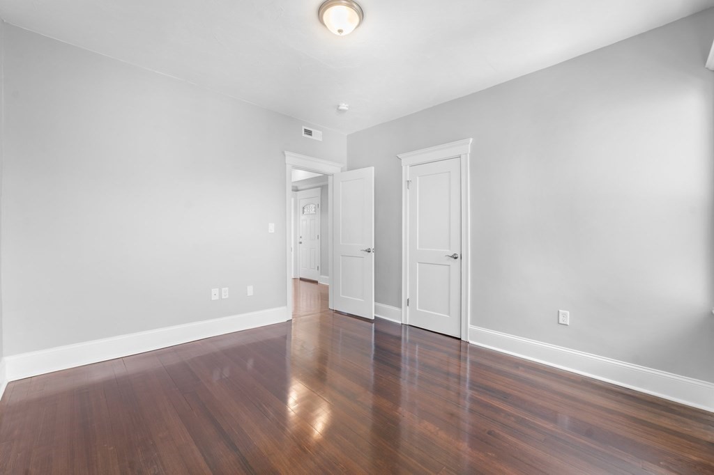 44 Bowdoin Street, Unit 2 Boston, MA 02124 - Photo 27 of 33 a view of an empty room with wooden floor