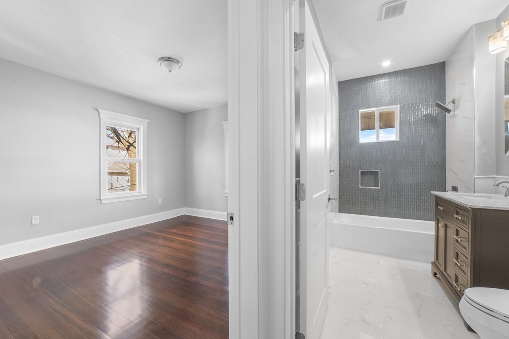 44 Bowdoin Street, Unit 2 Boston, MA 02124 - Photo 28 of 33 a spacious bathroom with a bathtub and a shower