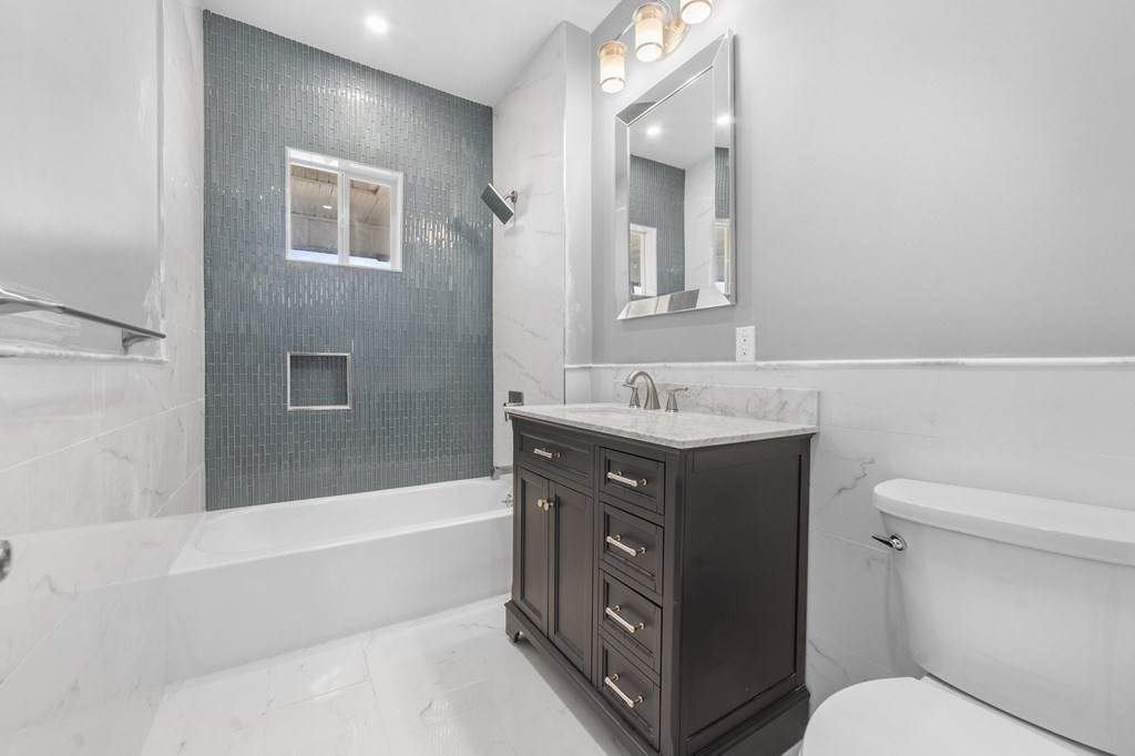 44 Bowdoin Street, Unit 2 Boston, MA 02124 - Photo 29 of 33 a bathroom with a sink a toilet and bathtub