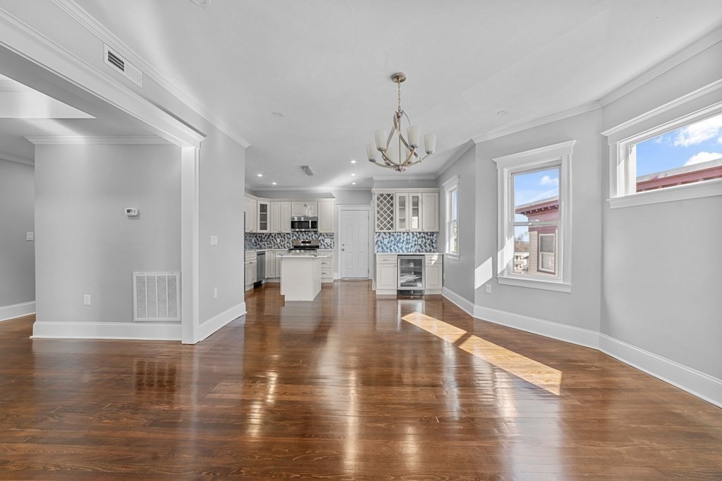44 Bowdoin Street, Unit 2 Boston, MA 02124 - Photo 7 of 33 a view of empty room with wooden floor and window