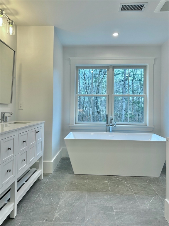 16 R Eldor Drive Walpole, MA 02071 - Photo 12 of 28 a spacious bathroom with a tub sink and mirror