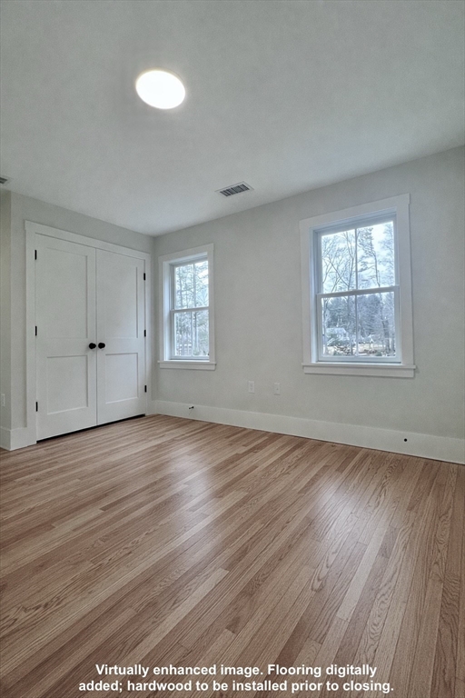 16 R Eldor Drive Walpole, MA 02071 - Photo 15 of 28 an empty room with wooden floor and windows